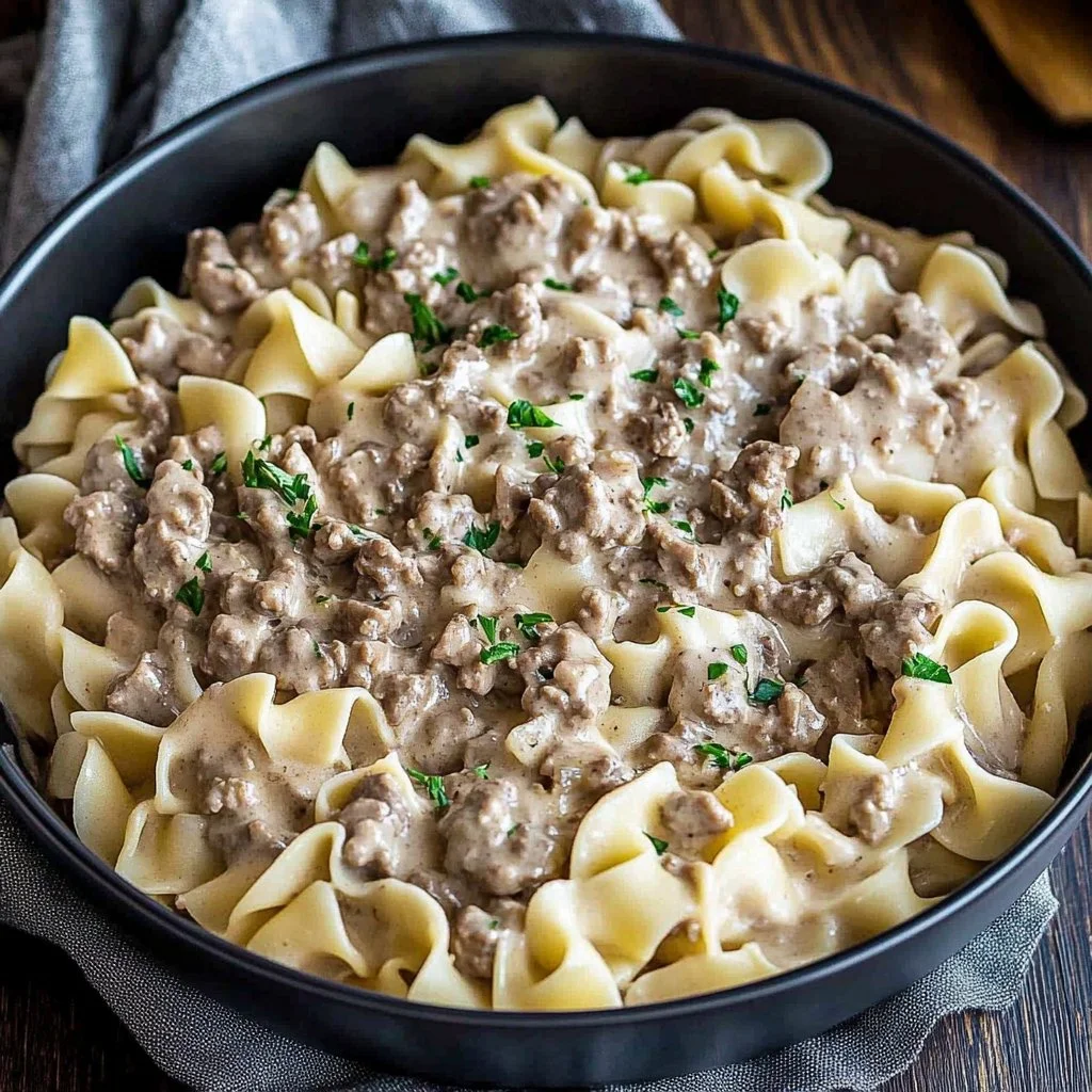 Delicious ground beef stroganoff served over egg noodles with a creamy sauce