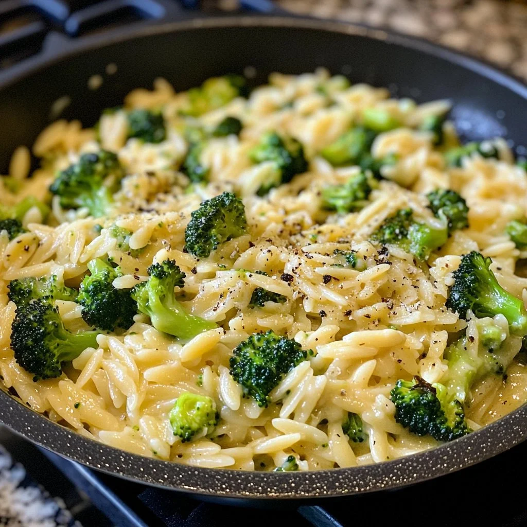 A delicious bowl of One Pot Broccoli Cheese Orzo topped with melted cheese.