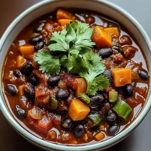 Bowl of sweet potato and black bean chili garnished with cilantro