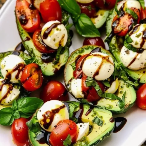 Avocado Caprese Boats served on a platter with basil and balsamic glaze