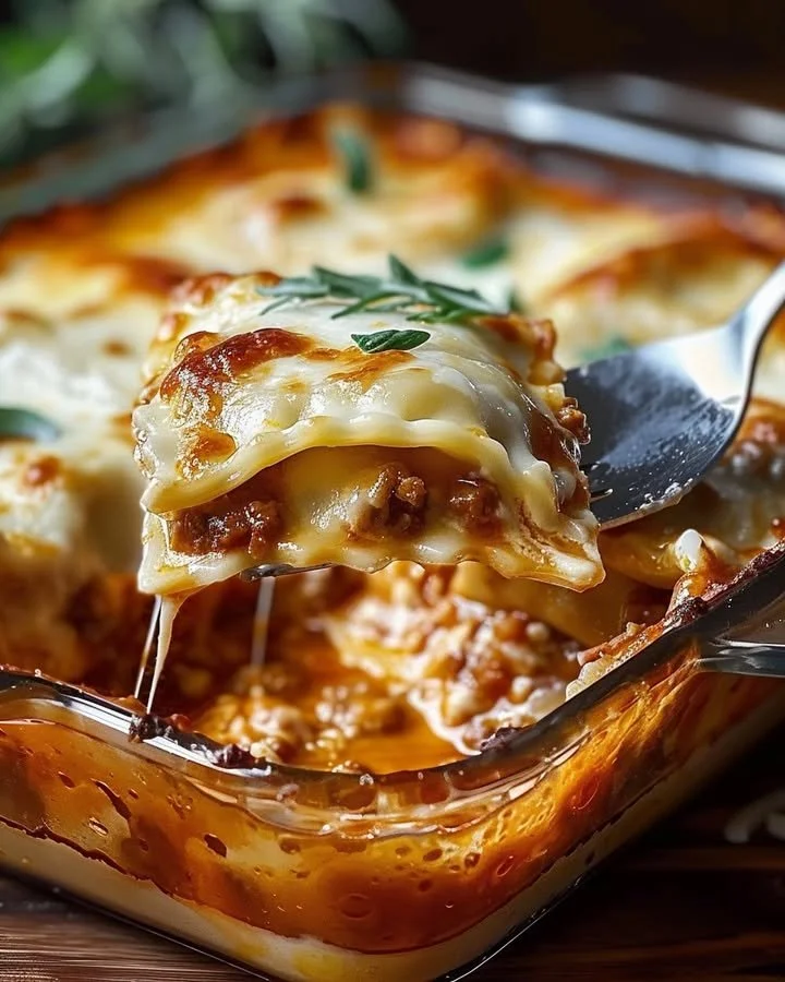 Baked Ravioli Casserole topped with cheese and herbs in a baking dish.