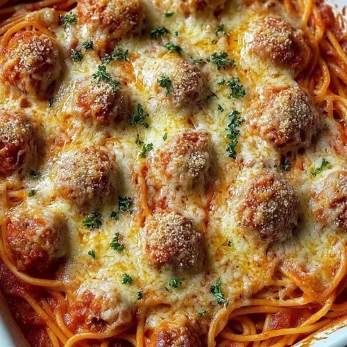 Delicious baked spaghetti meatballs served in a dish, garnished with parsley