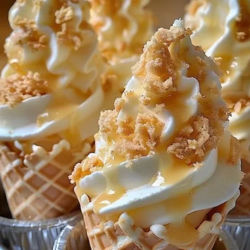 Banana pudding cheesecake cones topped with whipped cream and banana slices