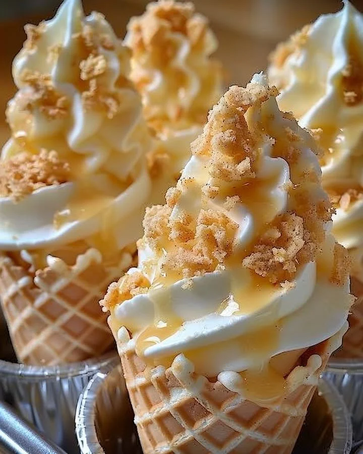Banana pudding cheesecake cones topped with whipped cream and banana slices