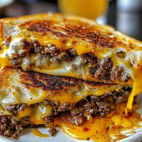 Beef grilled cheese sandwich with melted cheese and savory beef on toasted bread
