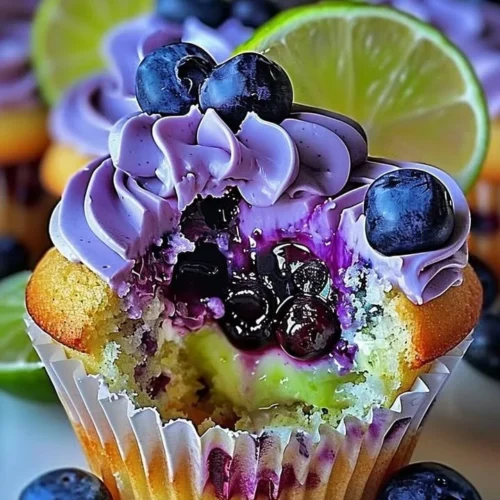 Blueberry lime cheesecake cupcakes topped with blueberry frosting and zest.