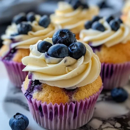 Blueberry white chocolate cupcakes topped with fresh blueberries