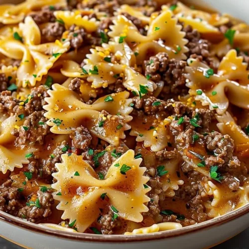 Delicious bowtie pasta with ground beef served in a bowl.
