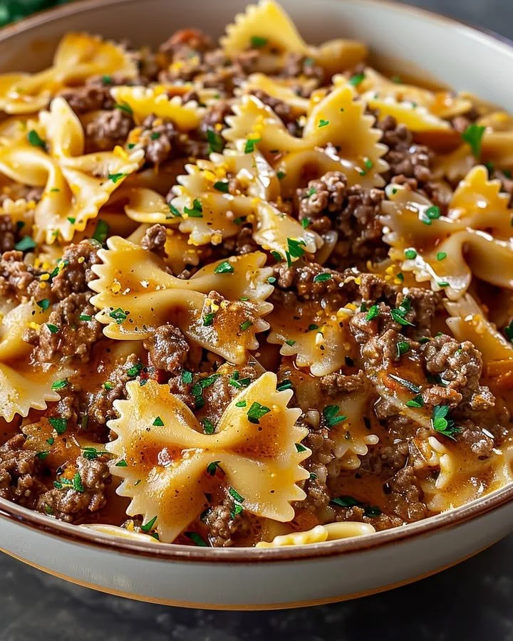 Delicious bowtie pasta with ground beef served in a bowl.