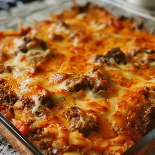 Delicious Cabbage Beef Bake served in a casserole dish with melted cheese.
