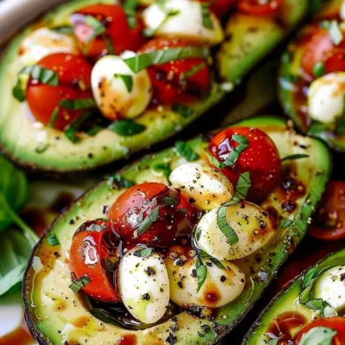 Delicious Caprese Stuffed Avocado with mozzarella, tomatoes, and basil