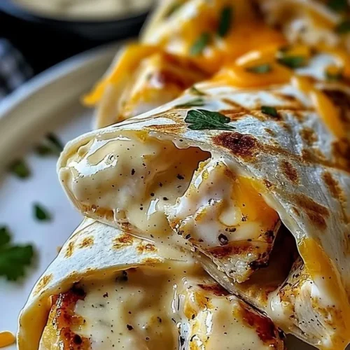 Cheesy garlic chicken wraps served on a plate, ready for dinner.