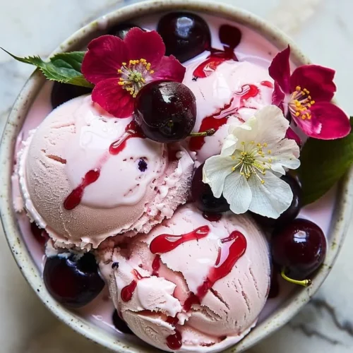 Cherry blossom ice cream in a bowl with cherry petals on top