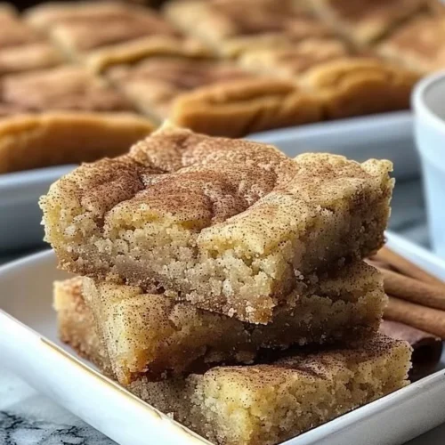 Chewy snickerdoodle cookie bars topped with cinnamon and sugar