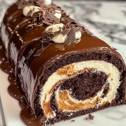 Delicious chocolate cake roll filled with creamy chocolate frosting