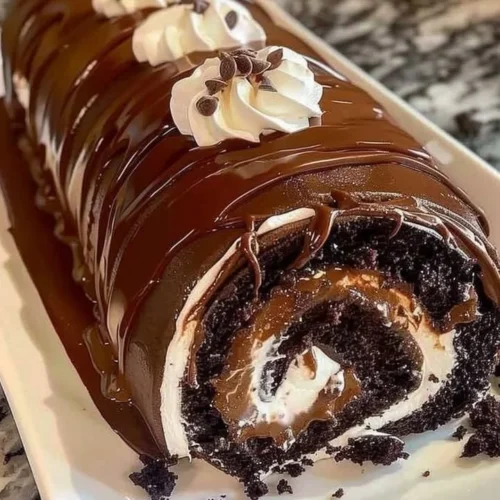 Delicious chocolate cake roll garnished with whipped cream and chocolate shavings