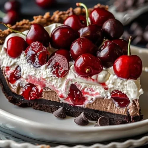 Delicious Chocolate Cherry Cream Pie topped with cherries and whipped cream