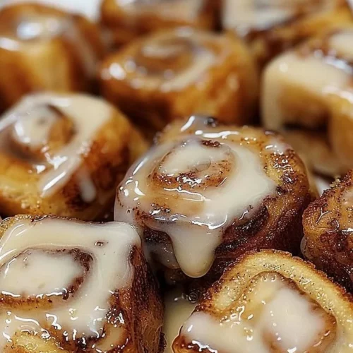 Cinnamon Roll French Toast Bites served with syrup and whipped cream