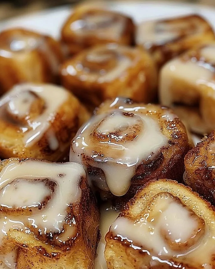 Cinnamon Roll French Toast Bites served with syrup and whipped cream