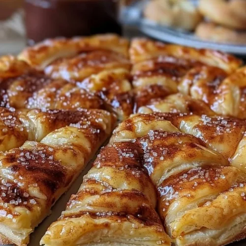 Cinnamon-sugar pizza made with crescent rolls, sprinkled with cinnamon and sugar.