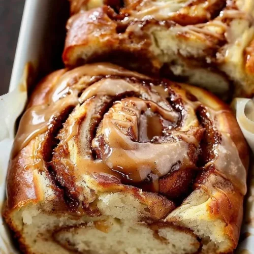 Loaf of homemade Cinnamon Swirl Bread displayed on a cutting board