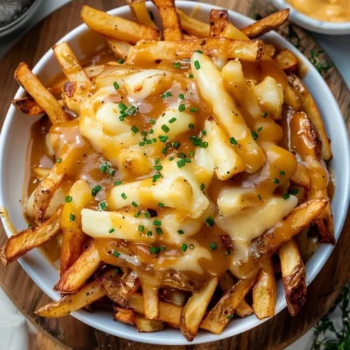 Delicious classic Canadian poutine with fries, cheese curds, and gravy
