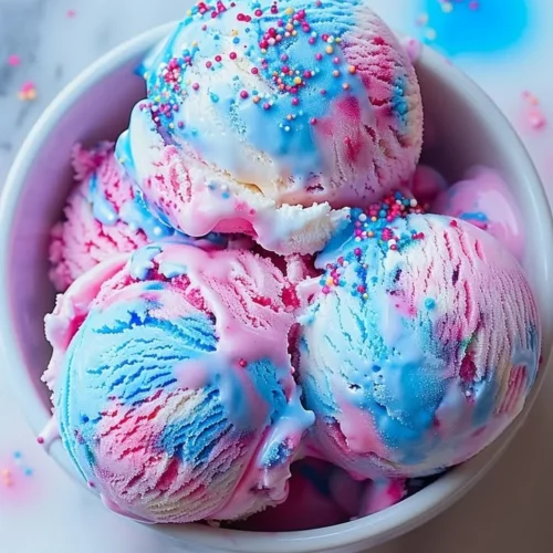 Delicious cotton candy ice cream in a colorful bowl.