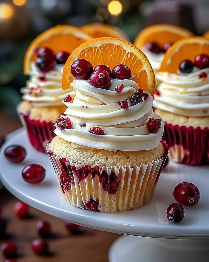 Cranberry Orange Cupcakes topped with white chocolate frosting