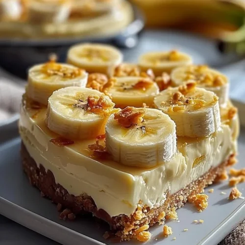 Creamy banana cheesecake topped with fresh bananas and whipped cream