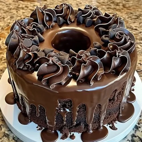 Death by Chocolate Cake topped with rich chocolate frosting and garnished with chocolate shavings