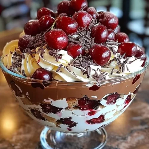 Decadent cherry chocolate trifle layered with cherries, chocolate mousse, and whipped cream