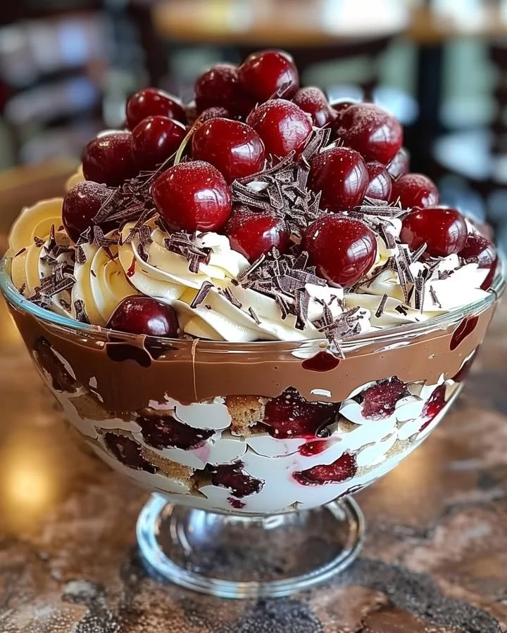 Decadent cherry chocolate trifle layered with cherries, chocolate mousse, and whipped cream