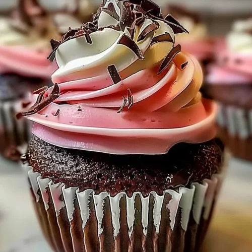 Decadent Neapolitan Cream Cupcakes with chocolate, vanilla, and strawberry layers