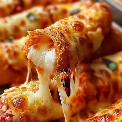 Doritos Pizza Rolls served on a plate with dipping sauce