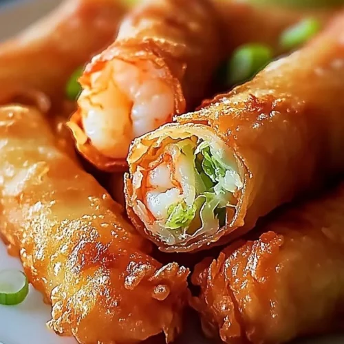 Crispy shrimp egg rolls with cabbage filling on a plate