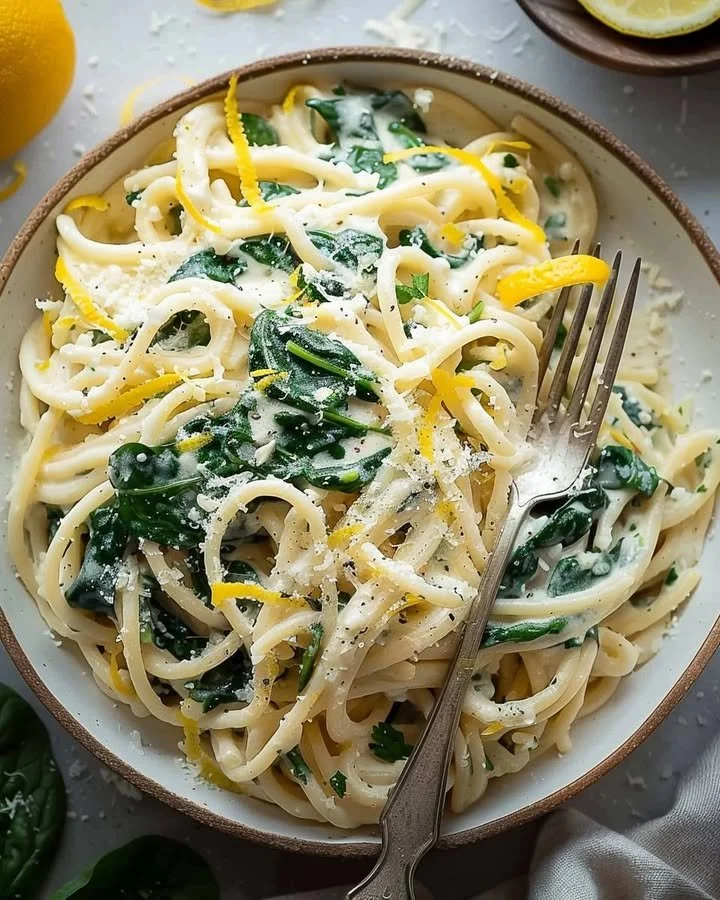 Delicious easy lemon ricotta pasta with fresh spinach served in a bowl.