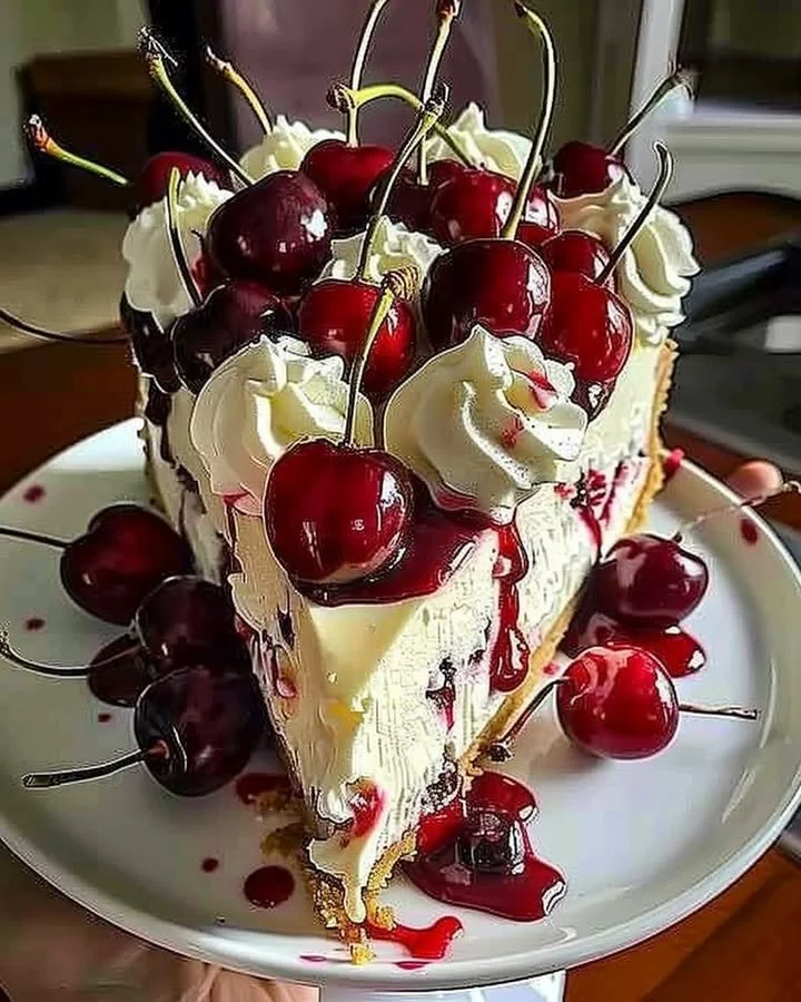 Elegant cherry cheesecake topped with fresh cherries and whipped cream
