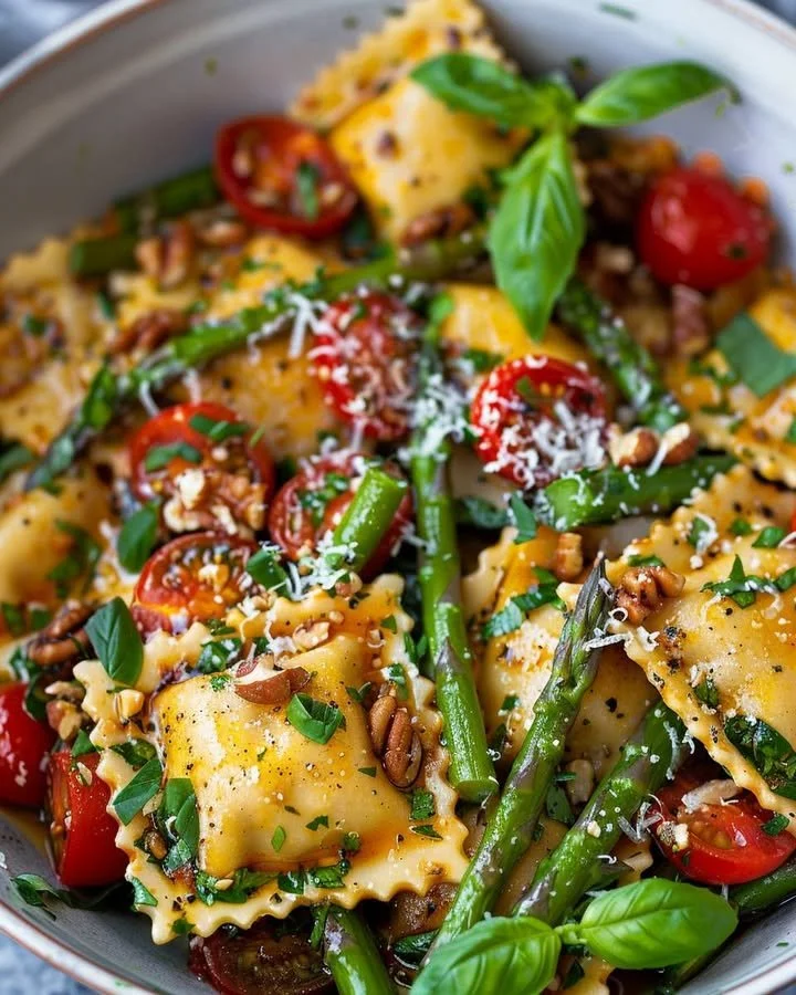 Plate of garden fresh asparagus ravioli tossed with tomatoes