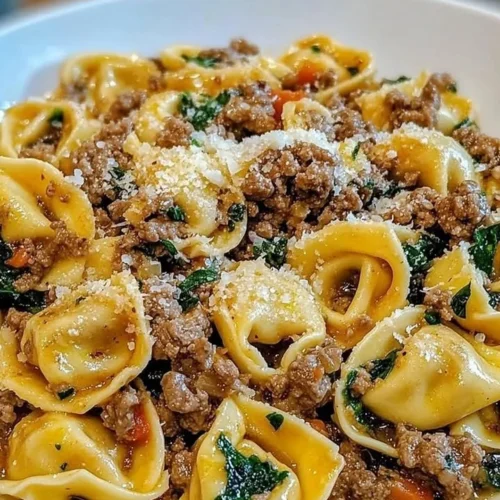 Delicious garlic butter and beef tortellini dish garnished with parsley.