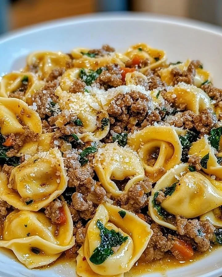 Delicious garlic butter and beef tortellini dish garnished with parsley.