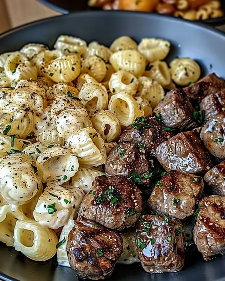 Delicious Garlic Butter Steak Bites served with creamy Parmesan pasta shells.