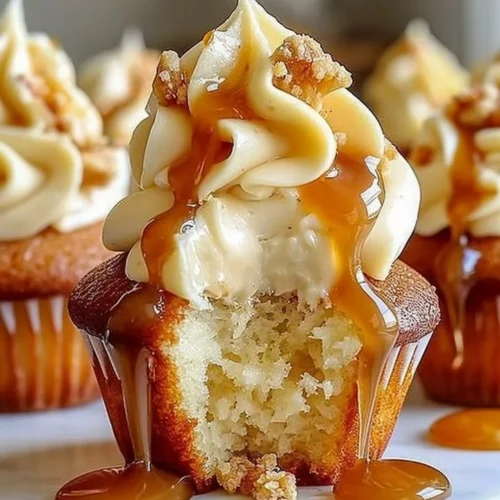 Gooey salted caramel cream cheese cupcakes with rich frosting and caramel drizzle