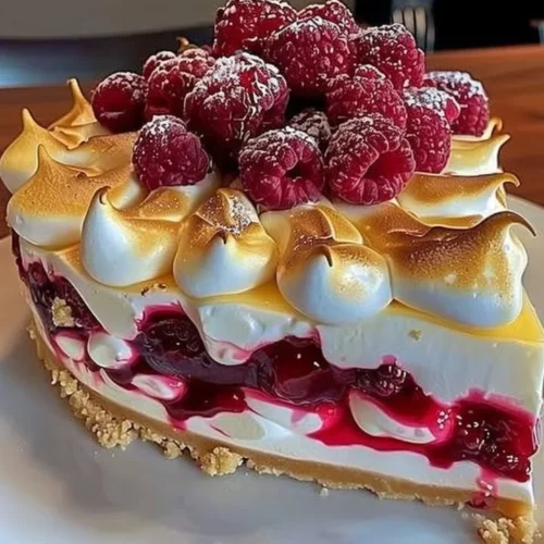 Heavenly lemon raspberry meringue cheesecake with vibrant raspberries and a creamy texture