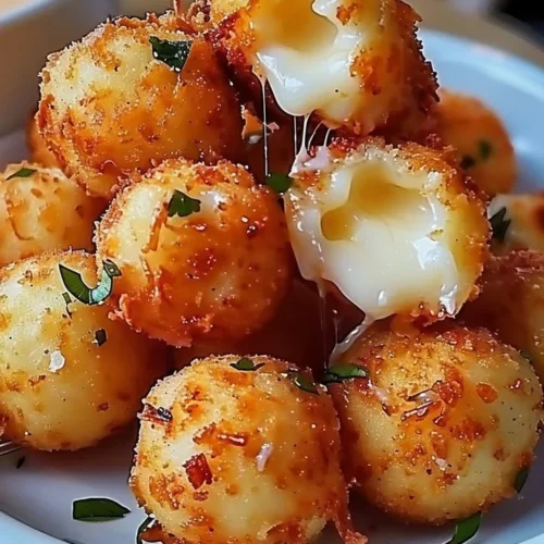 Plate of homemade fried cheese bites served with dipping sauce.
