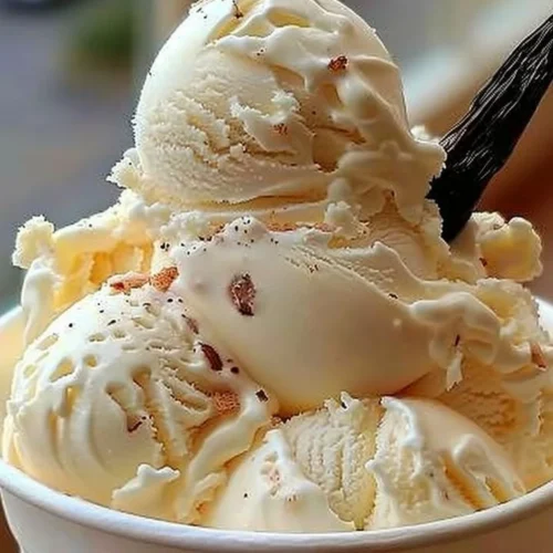 Bowl of homemade vanilla ice cream with fresh vanilla beans