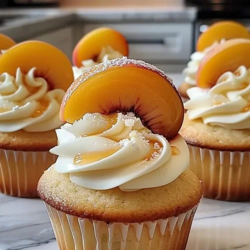 Honey Peach Cream Cheese Cupcakes topped with fresh peach slices and cream cheese frosting