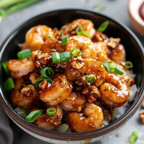 Delicious Honey Walnut Shrimp Delight garnished with walnuts and drizzled with honey.