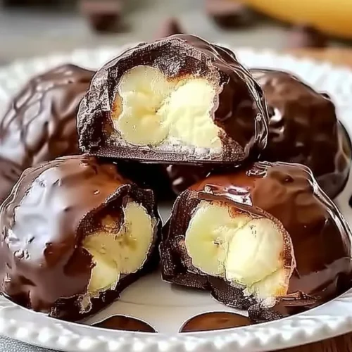 Irresistible banana pudding chocolate puffs dessert with layers of creamy banana and chocolate.