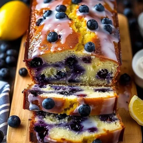 Lemon blueberry yogurt loaf with a golden crust and vibrant berries