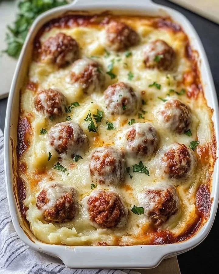 Loaded mashed potatoes casserole with meatballs served in a baking dish